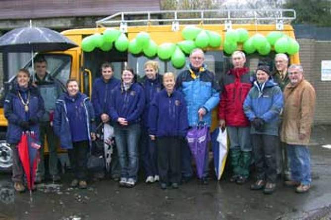 Picture of staff group and new minibus.